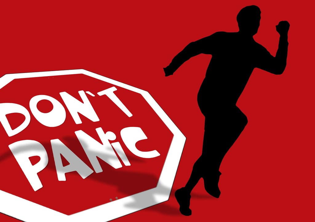 Panic attacks Red Don't Panic sign beside a silhouette of a running man
