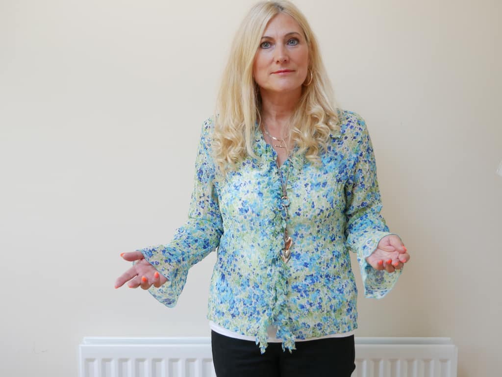 Sonya Hudson, clinical hypnotherapist Sonya Hudson standing with open hands as she speaks